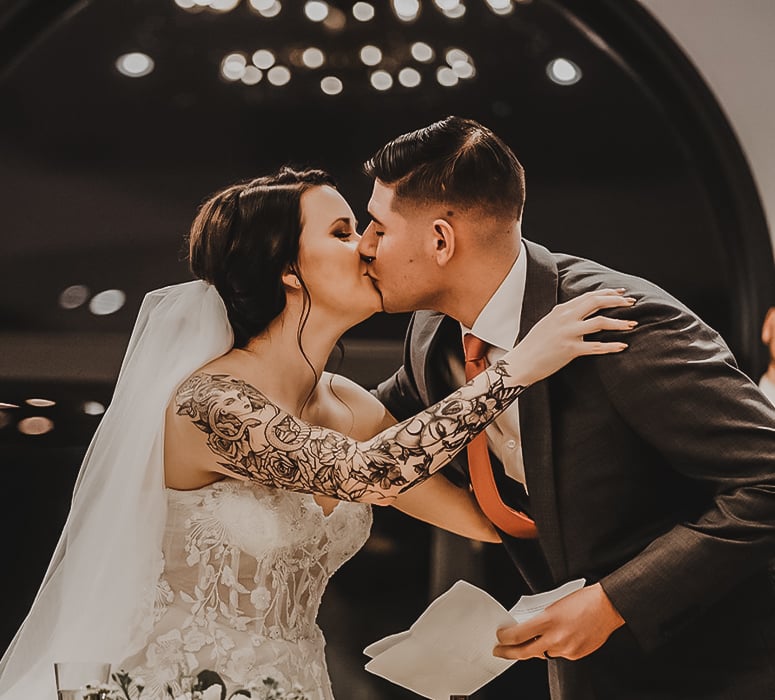 Kissing at the Sweetheart Table at Granite Rose