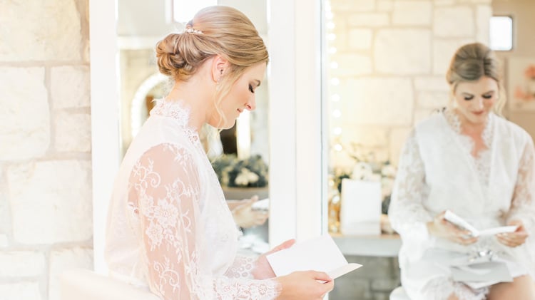 Courtney reads a love-felt note as she gets ready in the bridal suite