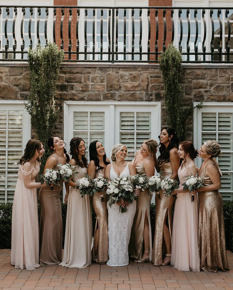 The bridal party sported beautiful mismatched dresses in gold, blush, and beige