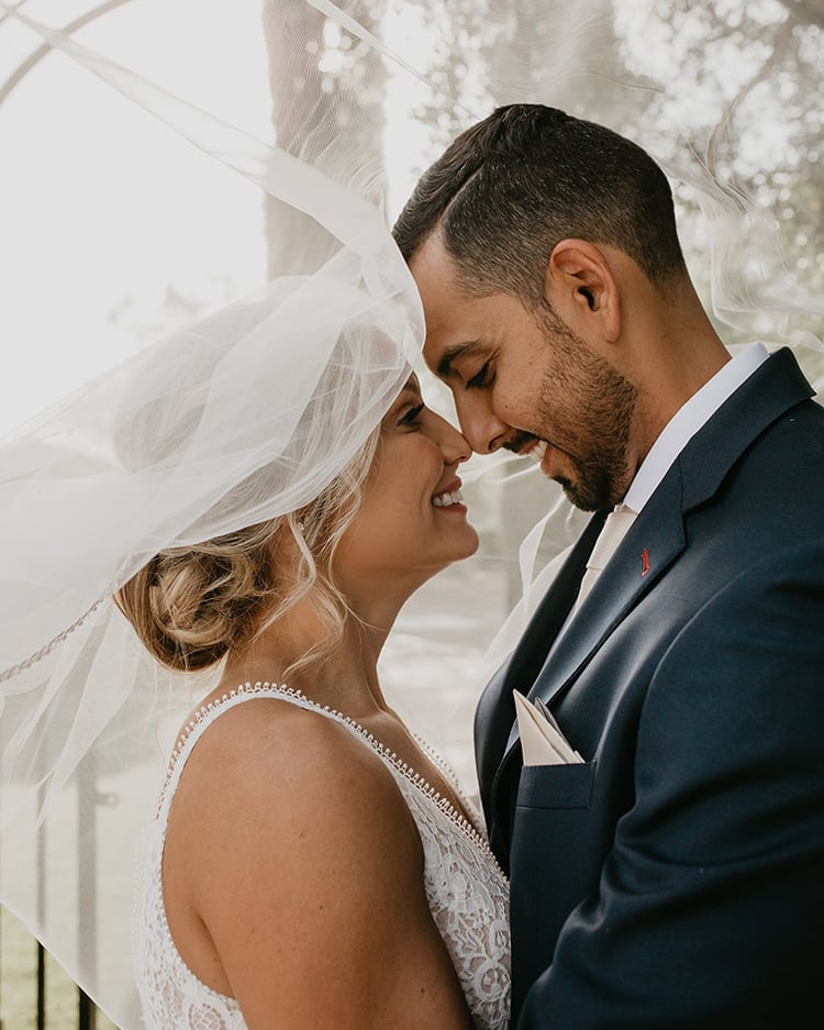 Lindsey & Marcos cocoon together under the billowing veil