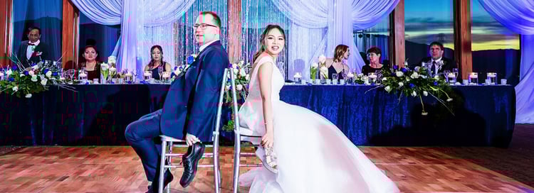 NEWLYWEDS PLAY THE SHOE GAME DURING THEIR BALLROOM WEDDING RECEPTION AT BOULDER RIDGE