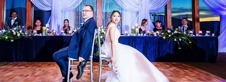 NEWLYWEDS PLAY THE SHOE GAME DURING THEIR BALLROOM WEDDING RECEPTION AT BOULDER RIDGE