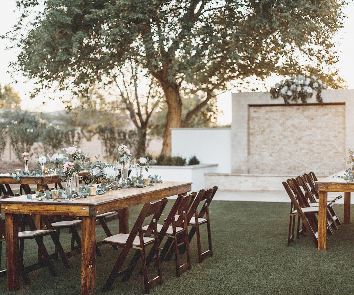 Outdoor reception with farm tables at Lindsay Grove