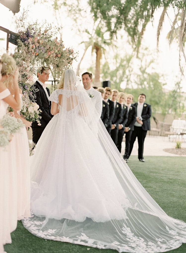 We opted for a beautiful garden ceremony with a floral arbor featuring pastel roses, baby's breath, and wispy greenery. The same bohemian-style florals were placed along the aisle and inside the reception ballroom. The ceremony was really beautiful, full of emotional anecdotes and laughter, with perfect weather to boot!