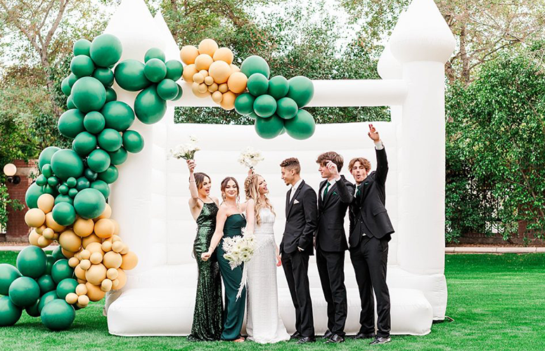 White Bounce Castle at a Green and Gold Wedding