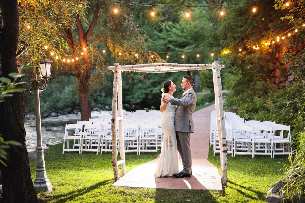 An outdoor wedding underneath the bistro lights at Boulder Creek in Colorado