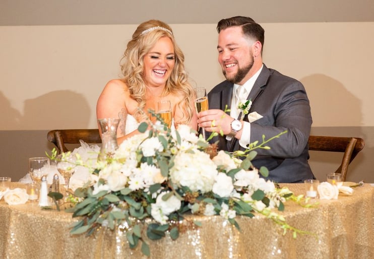 bride and groom at wedding reception table