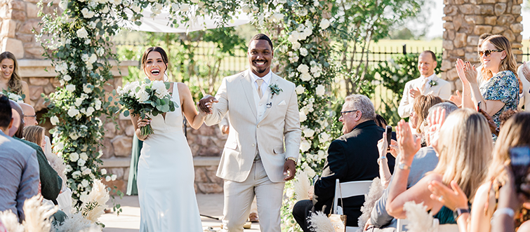 Bride and groom walking down the aisle after saying 'I do'