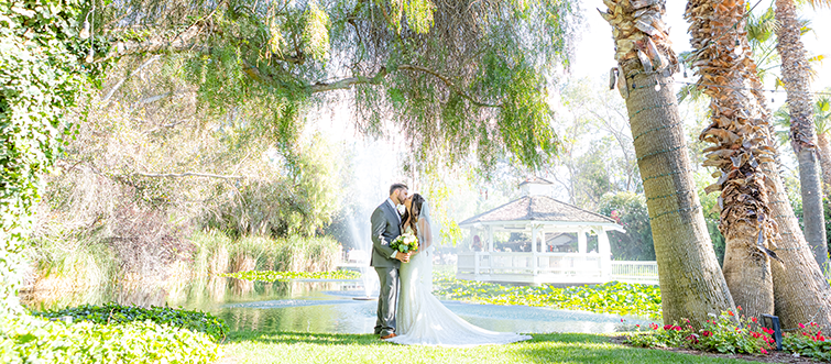 Couple posing in front of The Orchard