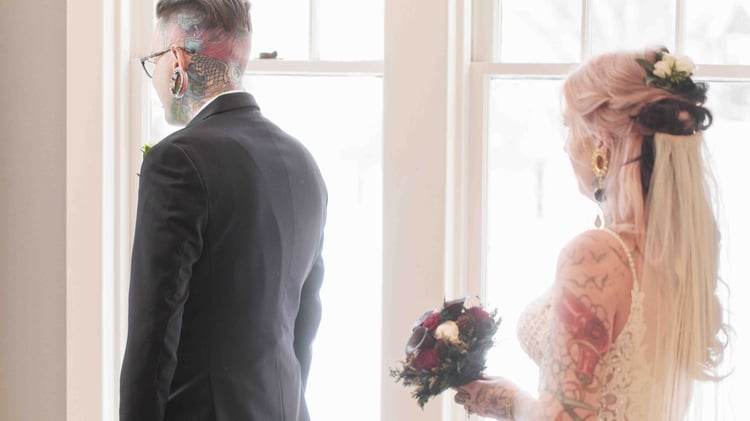 First look photo of a tattooed bride and groom at Boulder Creek