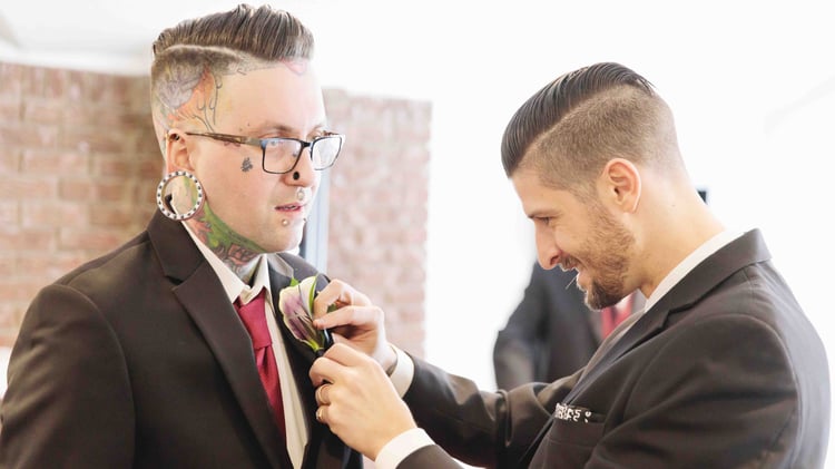 Groomsmen being pinned with a boutonniere