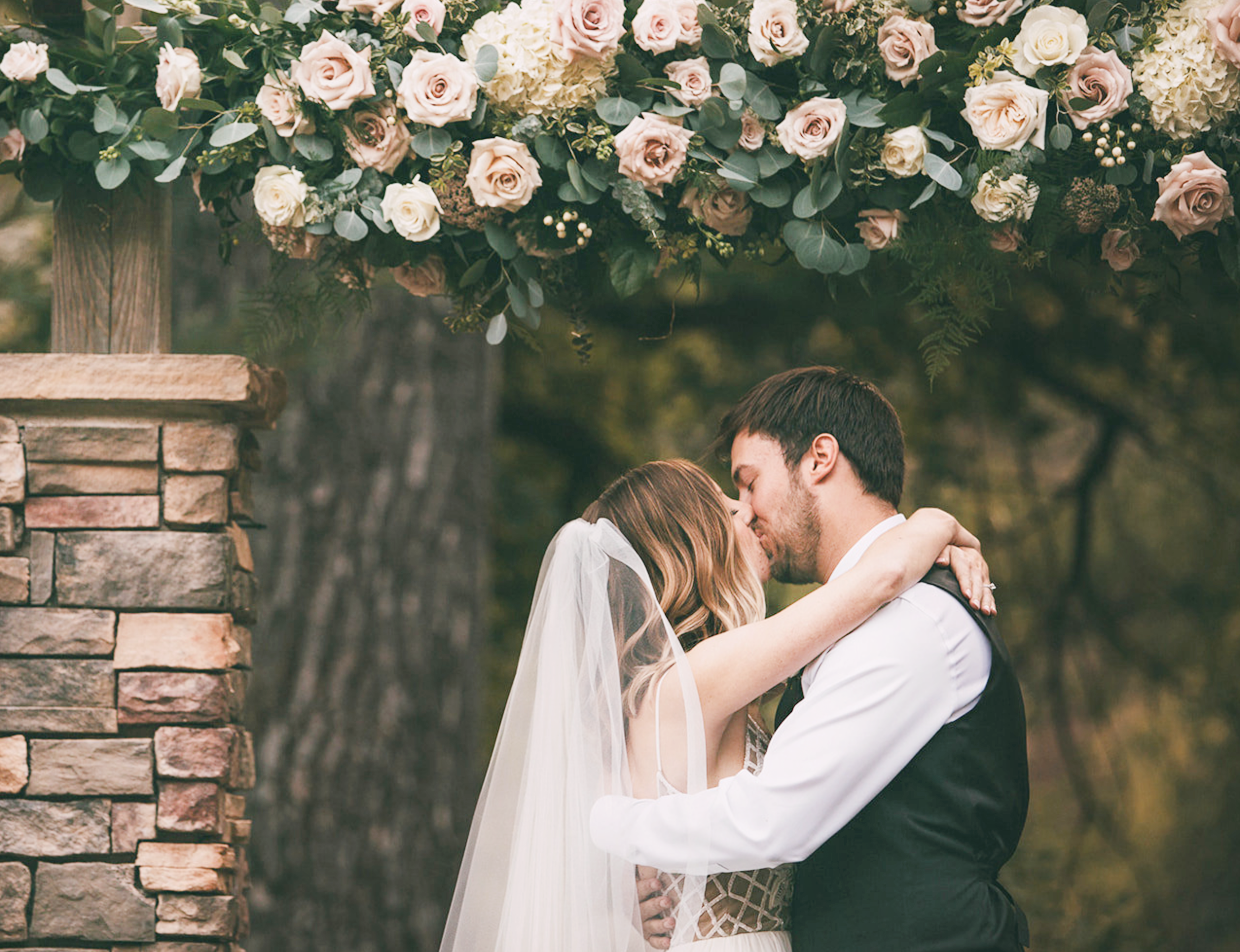 Stunning Stacked Stone Arbor With Floral Decor at Boulder Creek