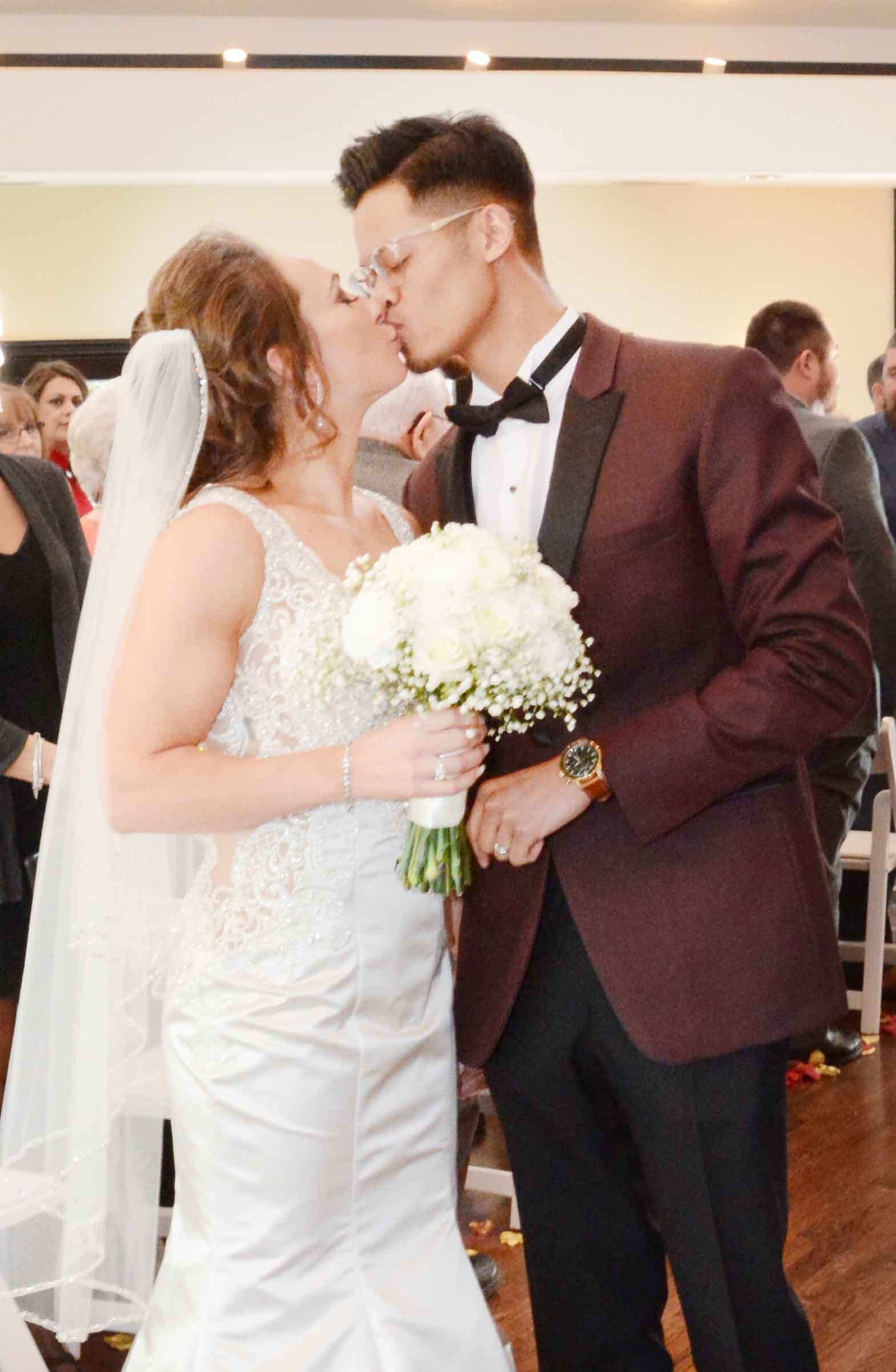 Newlyweds sealing the deal with a kiss at Granite Rose, NH