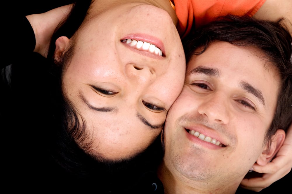 happy couple portrait with heads together on the floor