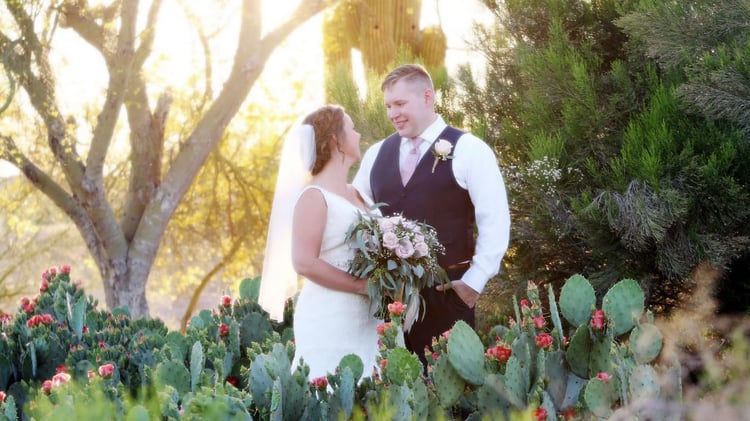 Kari and Matt share an intimate moment among the wild cactus garden