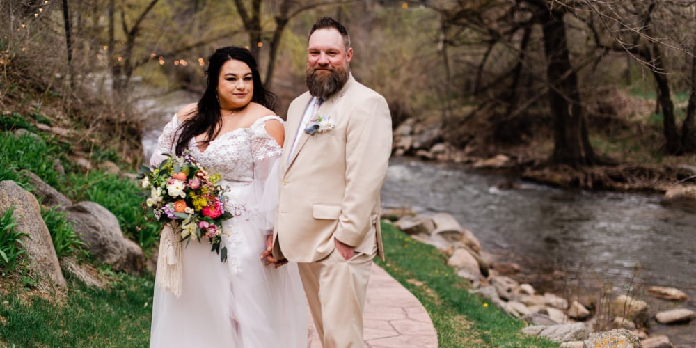 Couple standing next to the creek at Boulder Creek by Wedgewood Weddings