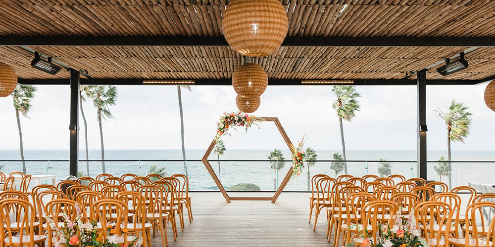 Ceremony with bold flowers - La Jolla Cove Rooftop by Wedgewood Weddings