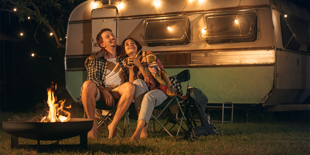 Couple camping by rv under the stars