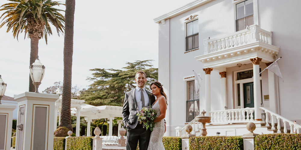 Couple in front of Jefferson Street Mansion by Wedgewood Weddings