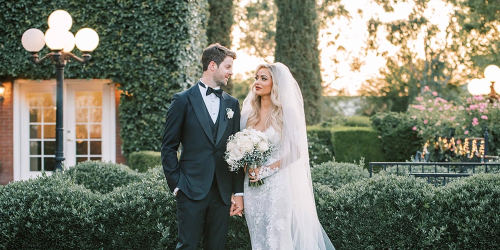 Couple in front of house at Stonebridge Manor by Wedgewood Weddings