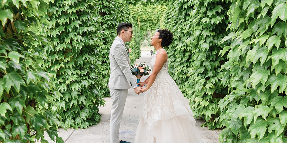 Couple in green ivy tunnel at University Club by Wedgewood Weddings