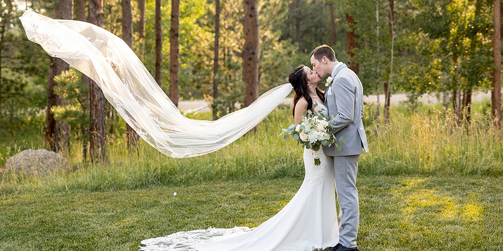 Couple kissing in forest at Black Forest by Wedgewood Weddings