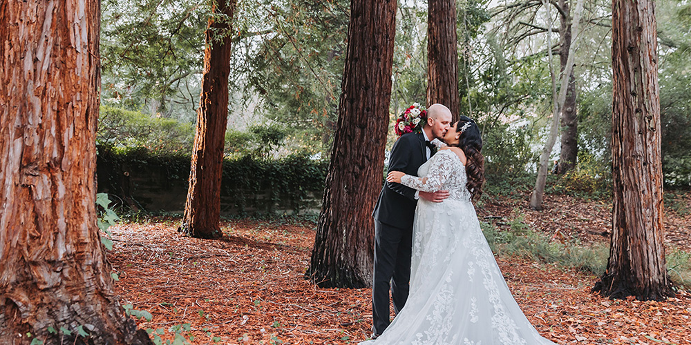 Couple kissing in forest at Hacienda de las Flores by Wedgewood Weddings