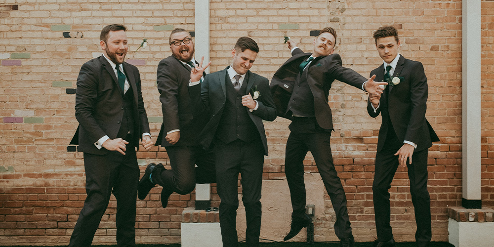 Groomsmen jumping and cheering at Tre Bella by Wedgewood Weddings