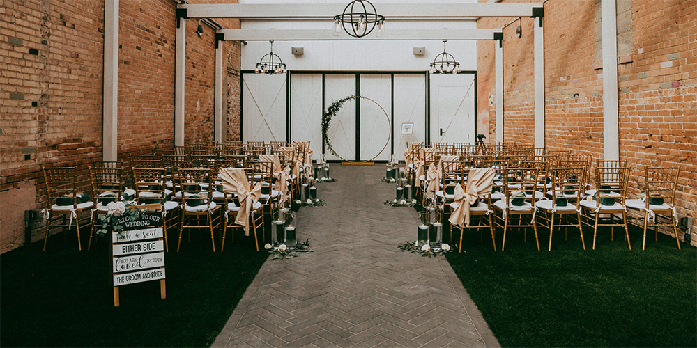 Outdoor ceremony with arch and decor at Tre Bella by Wedgewood Weddings