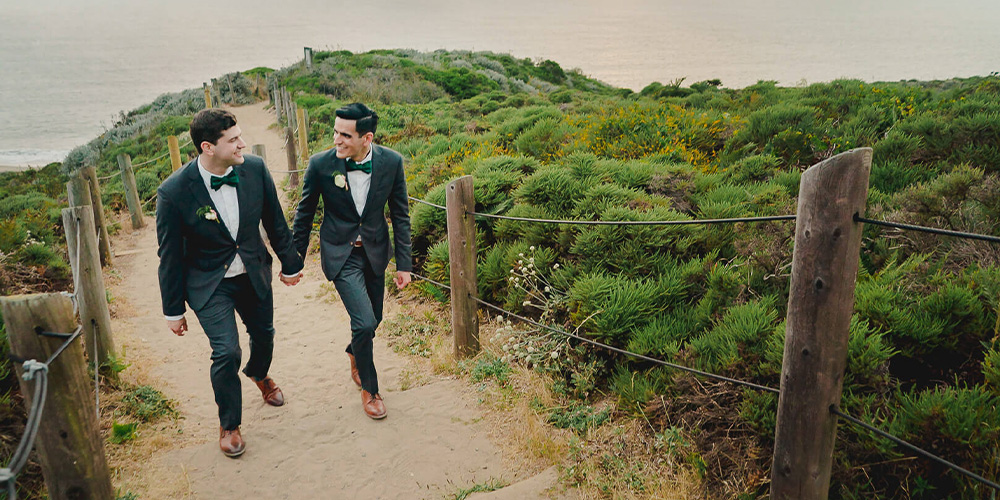 Two grooms enjoying the beach at the Presidio by Wedgewood Weddings
