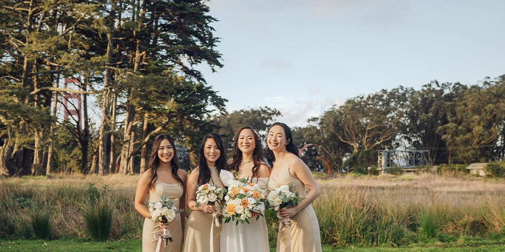 Wedding party in front of Golden Gate Bridge at Log Cabin at The Presidio