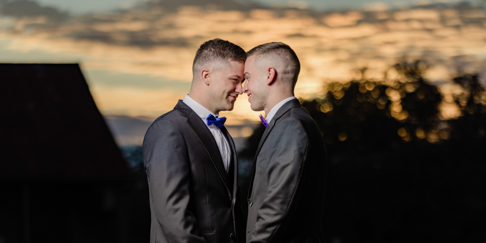 Two grooms at sunset