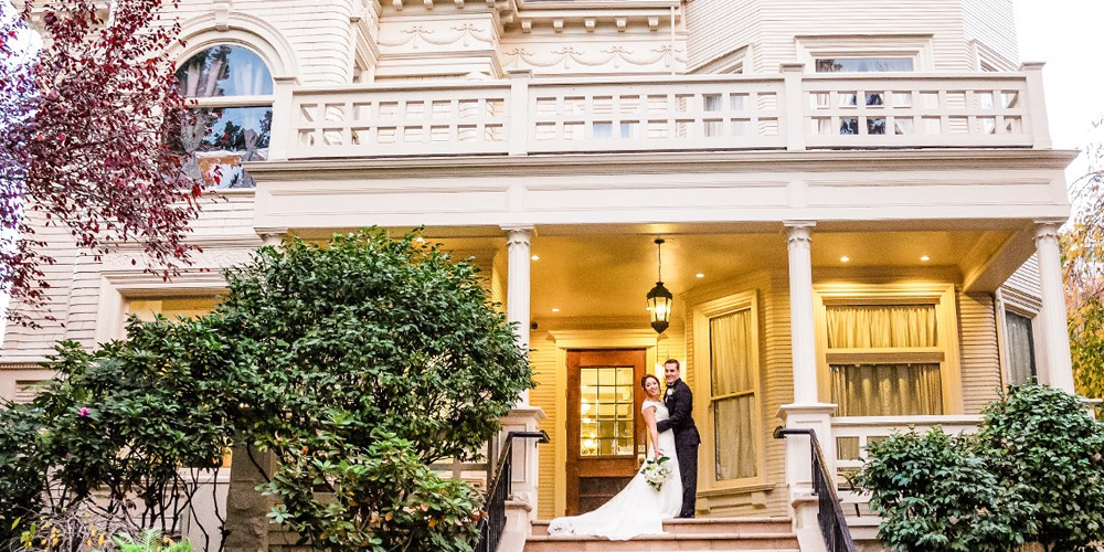 A bride and groom outside the Sterling Hotel by Wedgewood Weddings