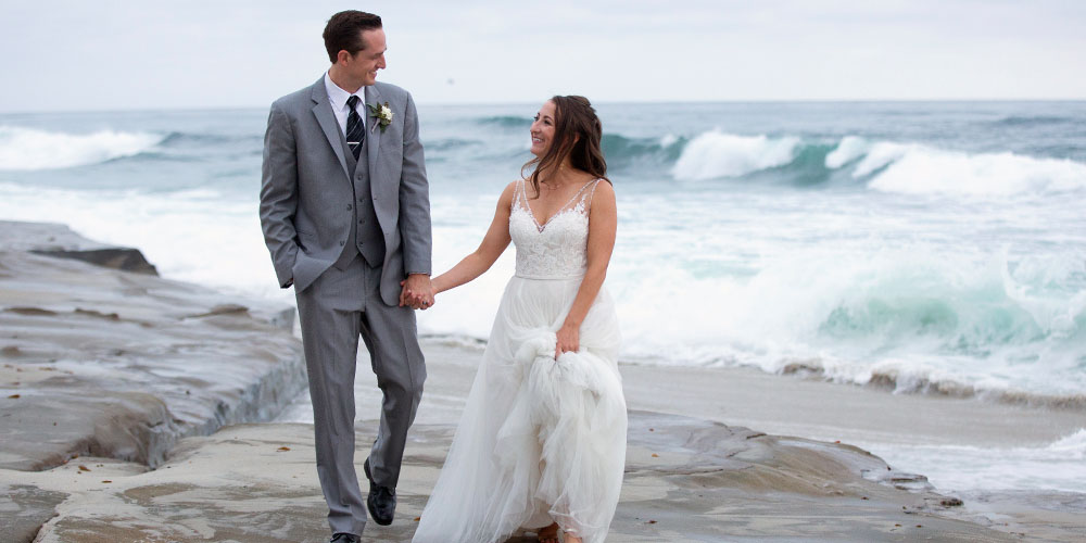 Husband and Wife walking in the sandy beaches of San Diego CA