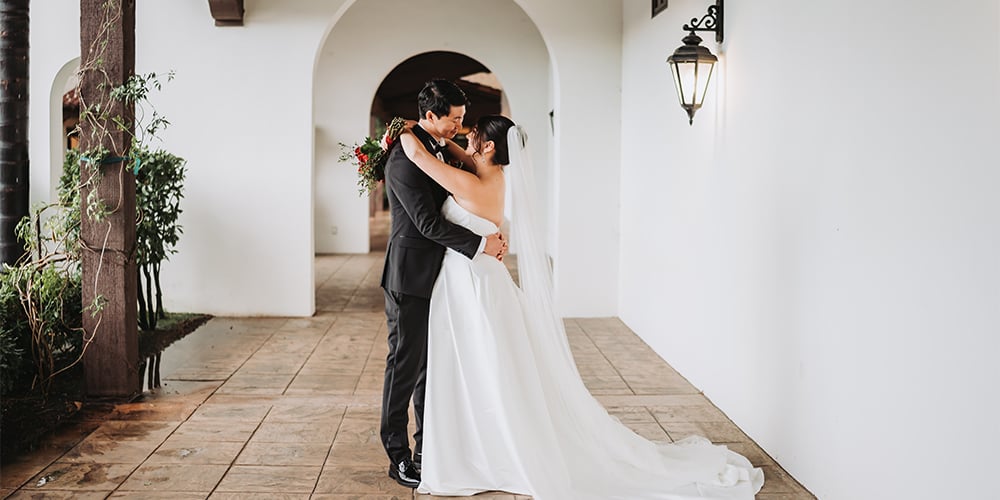Couple hugging after saying I Do in the hallway of Fallbrook Estate