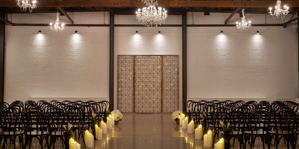 Wedding ceremony inside The Abbey at Croft Downtown Phoenix with exposed brick and dramatic architectural details
