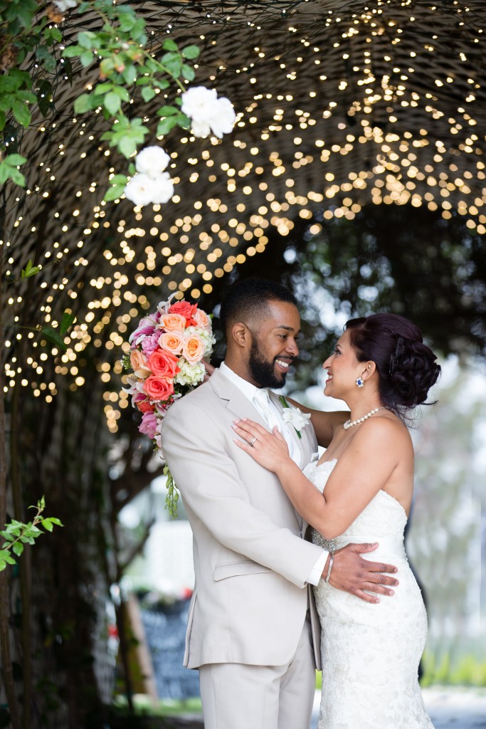 bride and groom under tree of lights