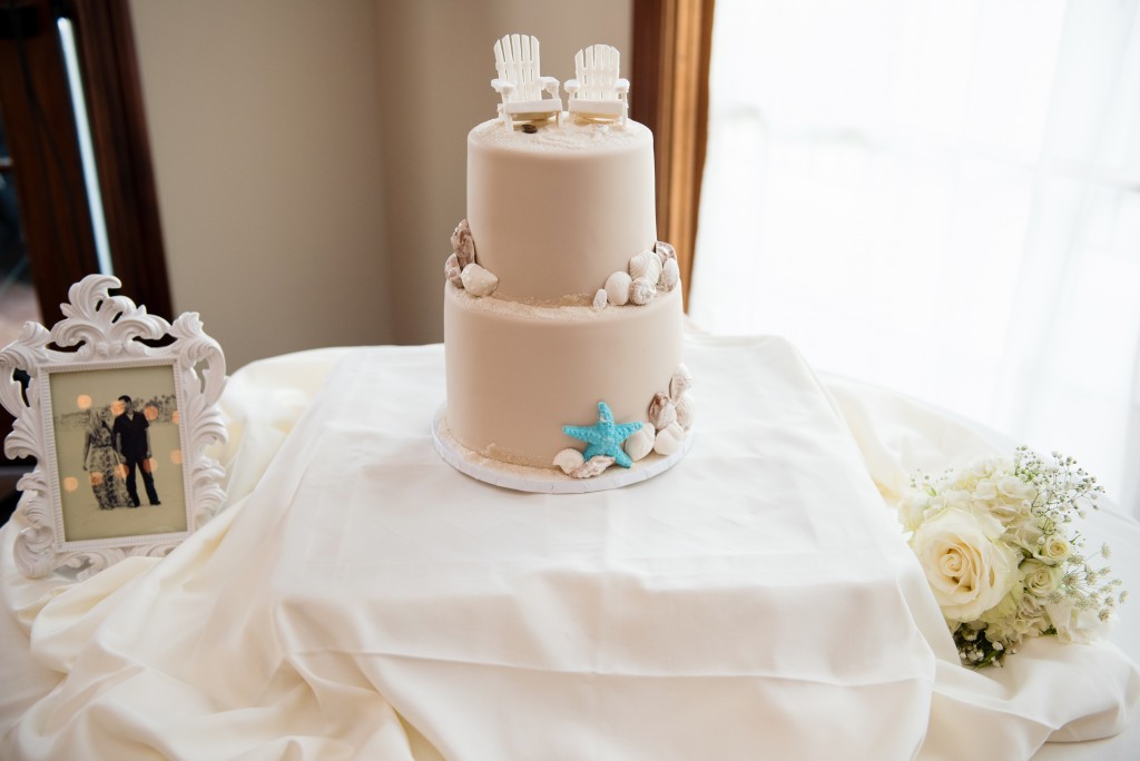 stunning beach wedding cake with sand cake topper