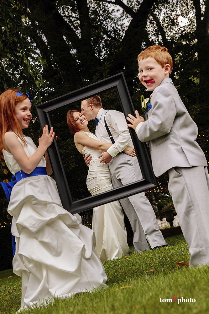Picture perfect ring bearer and flower girl holding frame