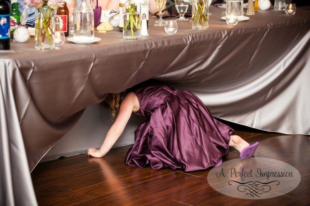 flower girl crawling under table