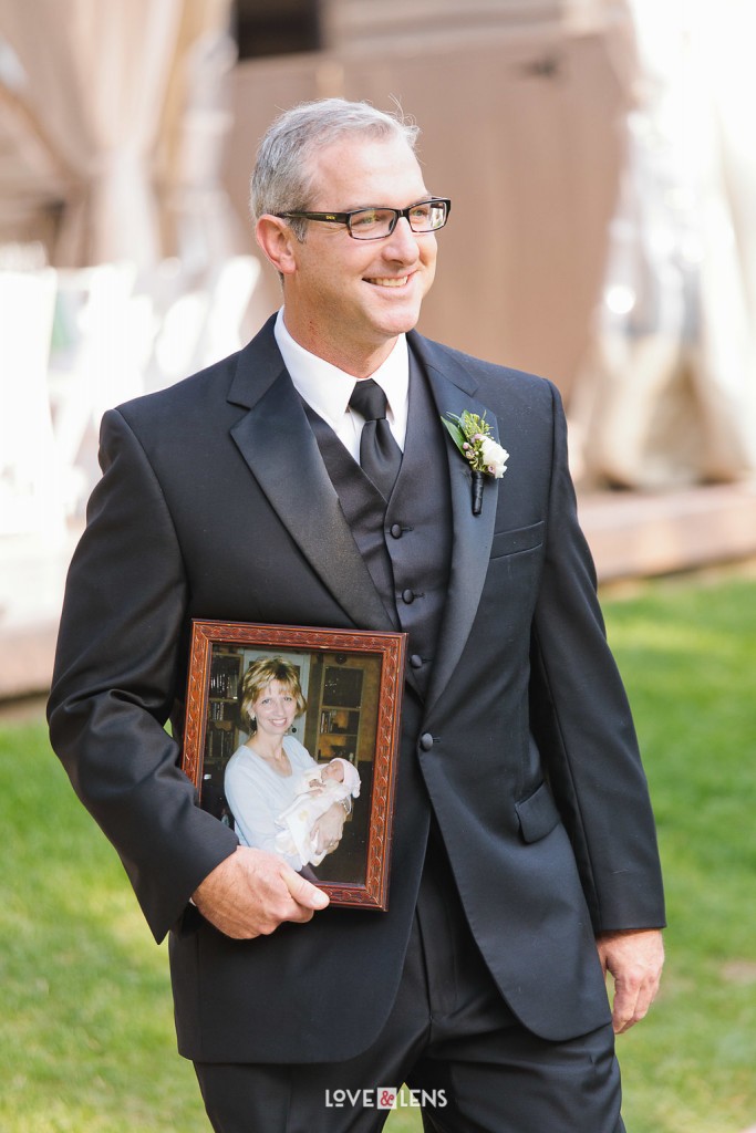 groomsman holding picture of mother