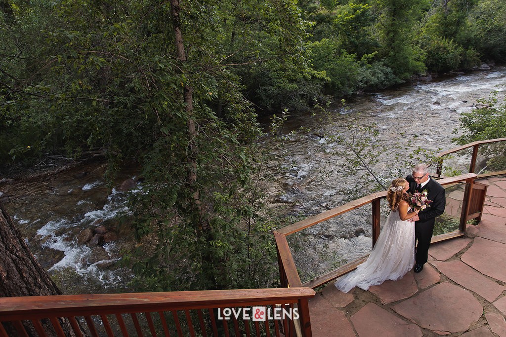 bride and groom by boulder creek