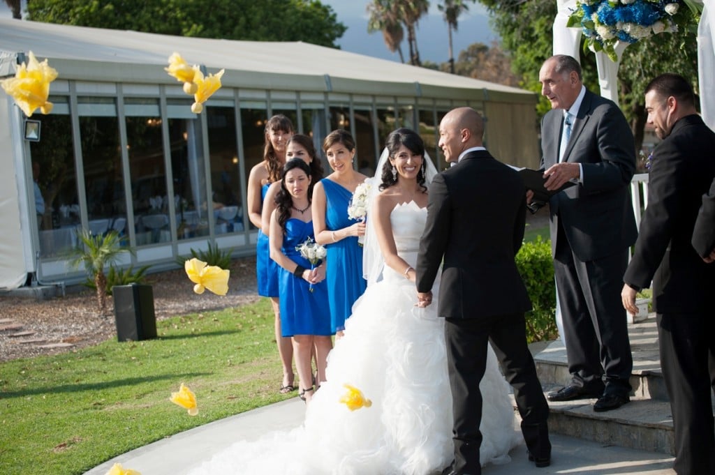 bride and groom at ceremony with yellow flags for sports theme wedding