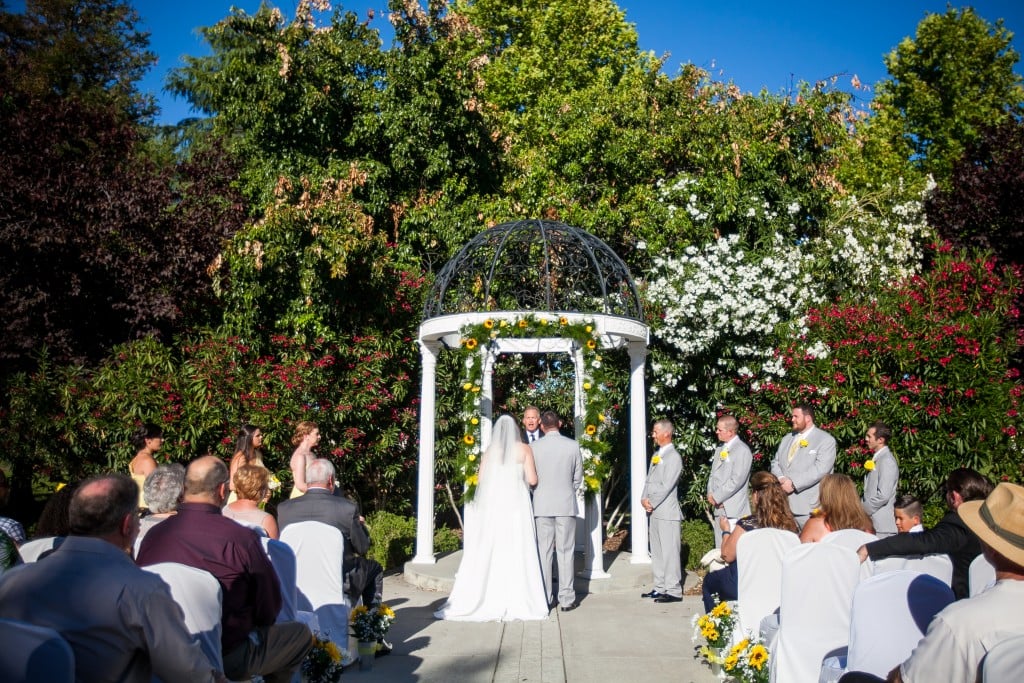 yellow wedding color scheme ceremony arch with sunflowers